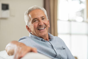 Portrait of happy senior man smiling at home. 